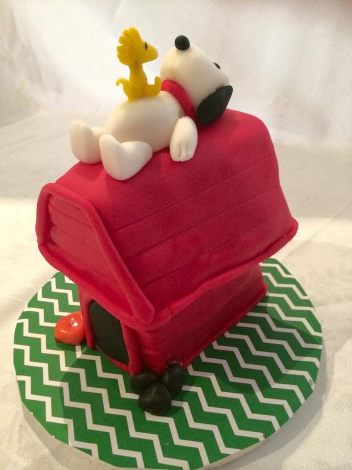 Queque temático de Snoopy sobre casa roja